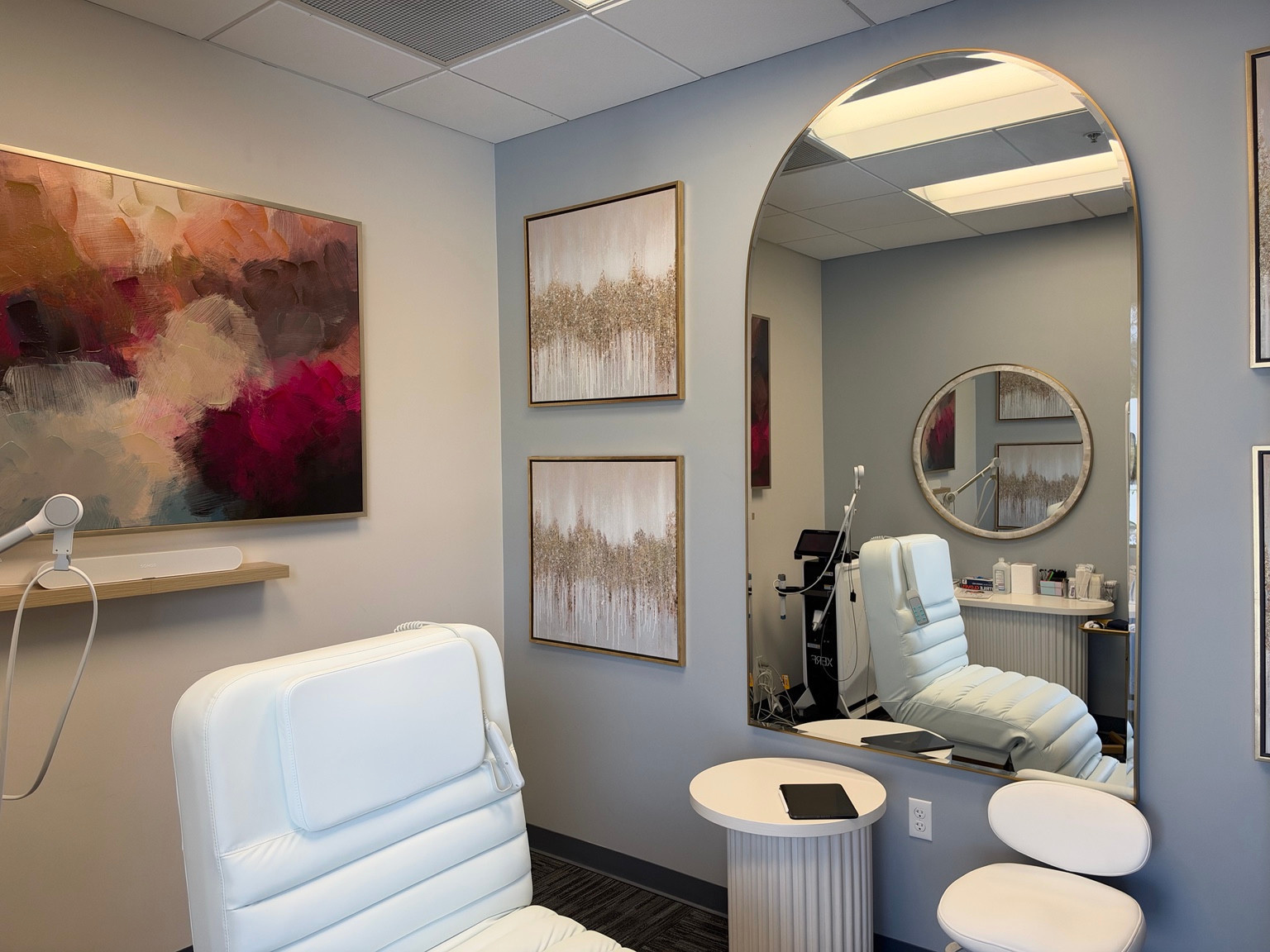 ZuVida treatment room with a reclining chair, care equipment, and an arched mirror